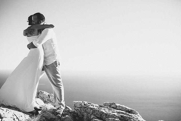 bride and groom hugging on croatian cliff