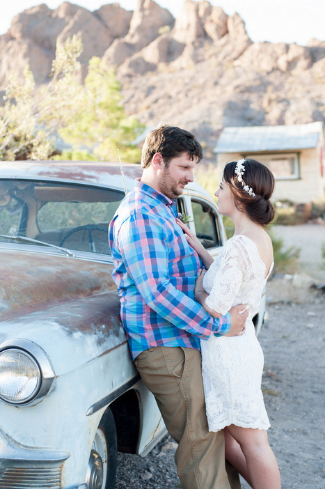 bride and groom next to vintage car