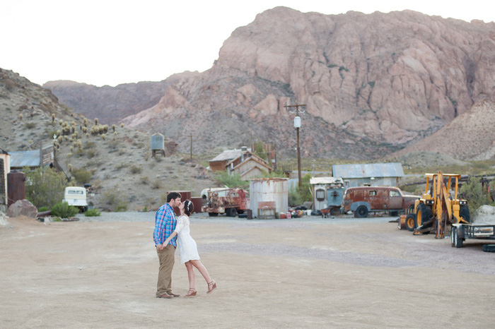 bride and groom kissing in the desert