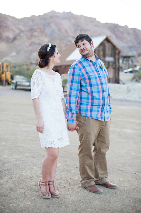 bride and groom walking in the desert