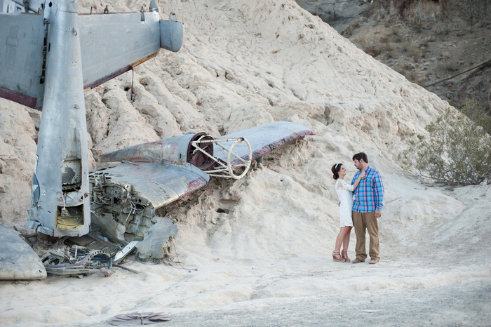 bride and groom portrait in the desert with plane wrackage