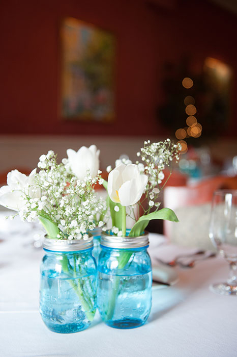 white tulips in blue jar