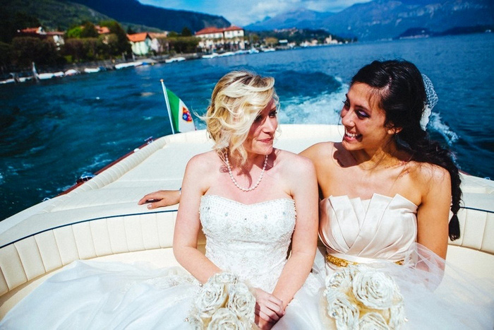 bride and maid of honor in boat on lake como