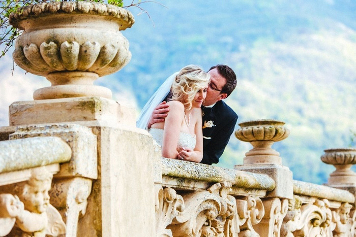 Bride and groom on villa balcony