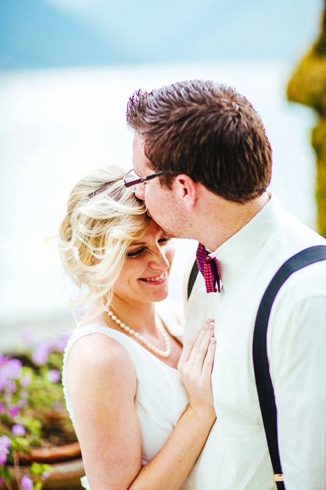 groom kissing bride on forehead