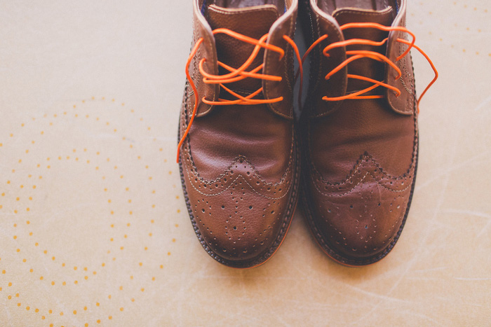 groom's wedding shoes with orange laces