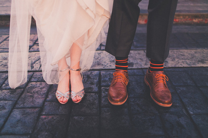 bride and groom showing off their shoes