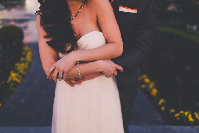 groom's arms wrapped around bride