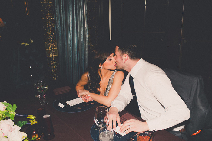 bride and groom kissing at reception