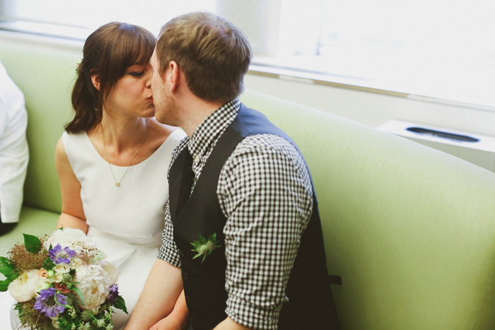 bride and groom kissing at city hall