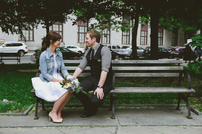 bride and groom sitting on New York City park bench