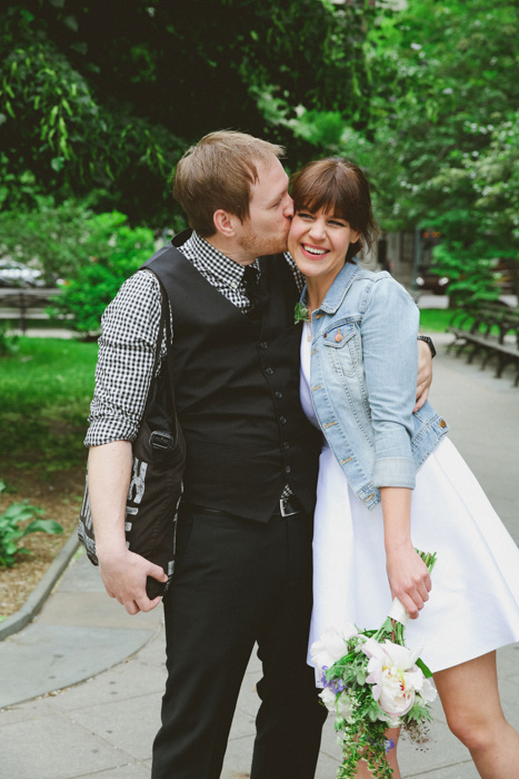 groom kissing bride on the cheek