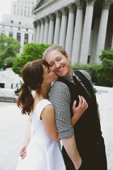 bride kissing groom on the cheek