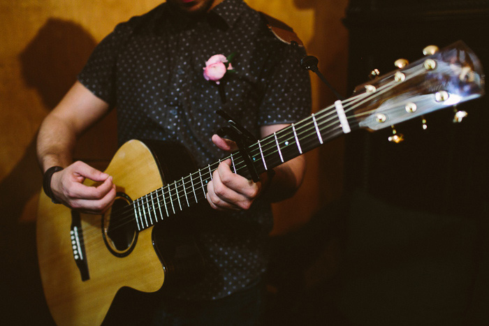 groomsman playing guitar