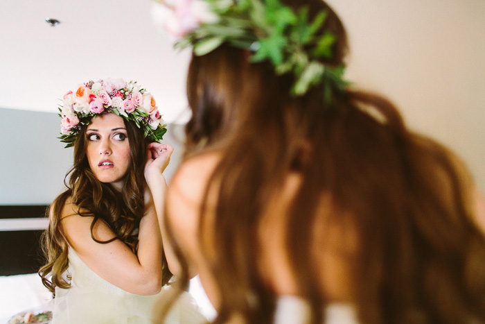 bride putting on flower crown