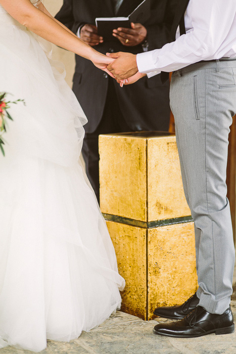 bride and groom holding hands during ceremony