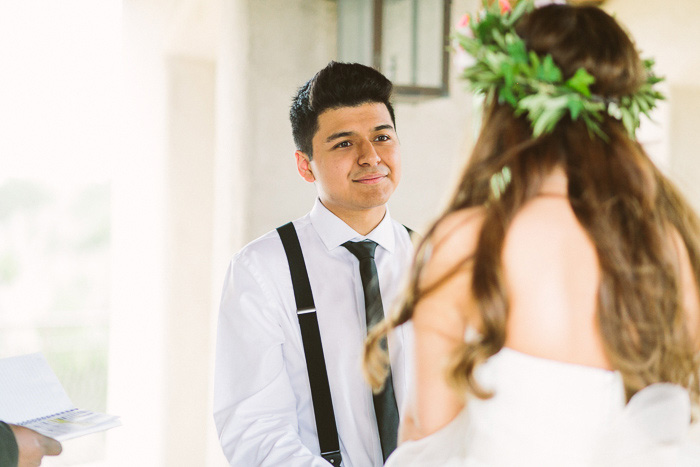 groom smiling lovingly at his brde