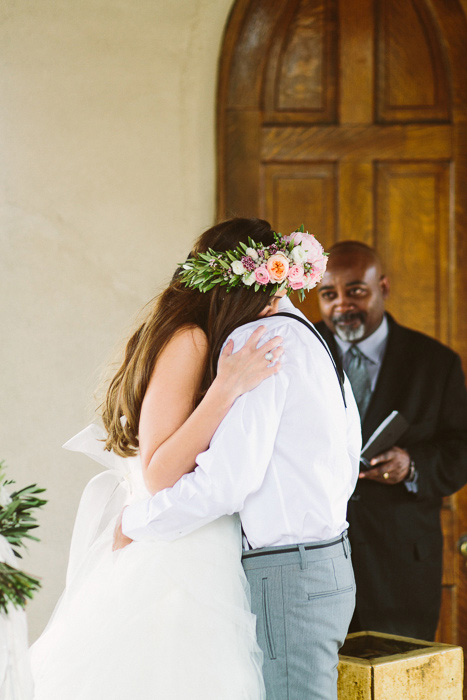 bride and groom hugging at wedding ceremony