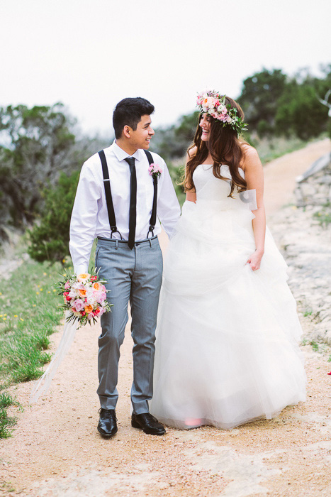 bride and groom walking along dirt road