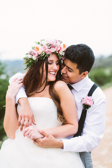 groom with arms draped over bride