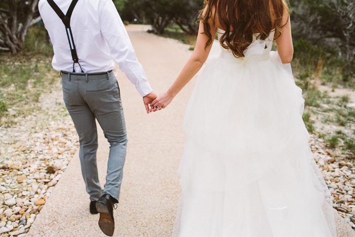 bride and groom walking away hand in hand