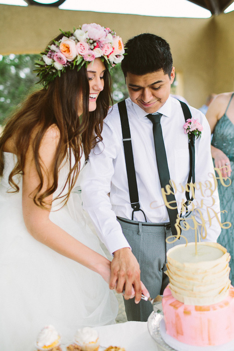 bride and groom cutting cake