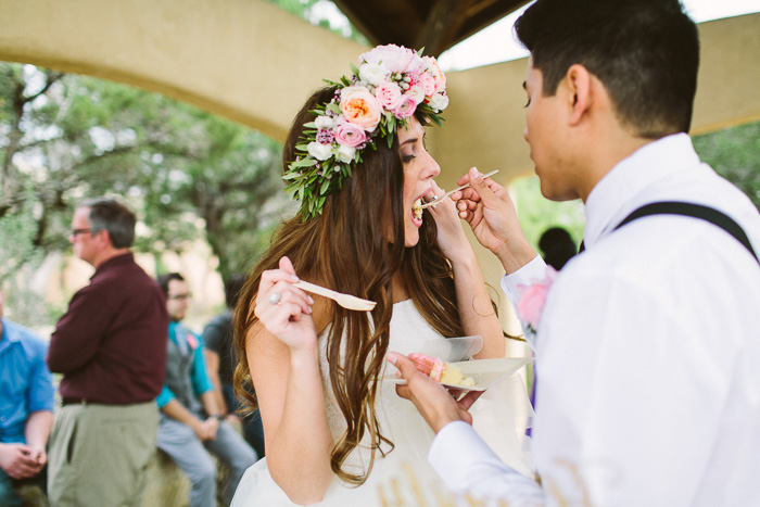 groom feeding bride cake