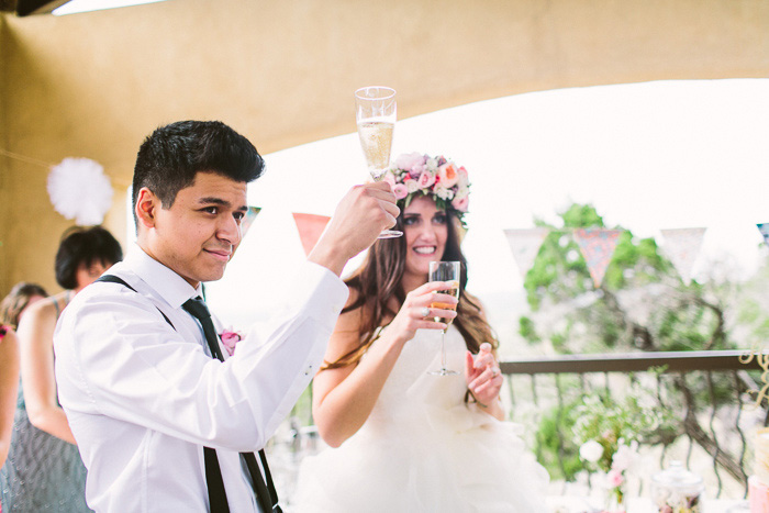 bride and groom raising their glasses