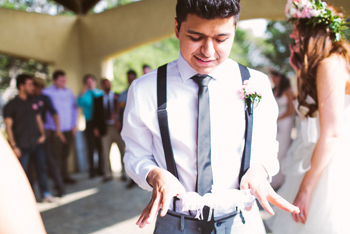 groom getting ready to toss the garter