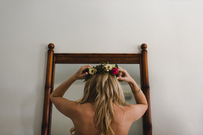 bride putting on flower crown