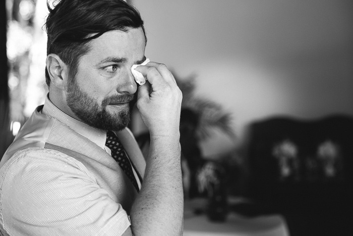 groom wiping away tears