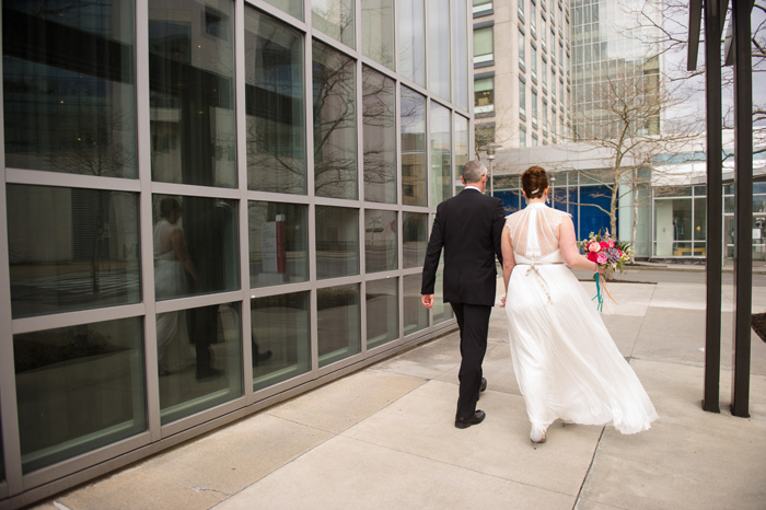bride and groom walking down street
