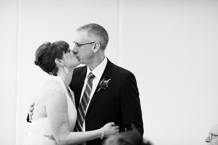 bride and groom kissing at reception