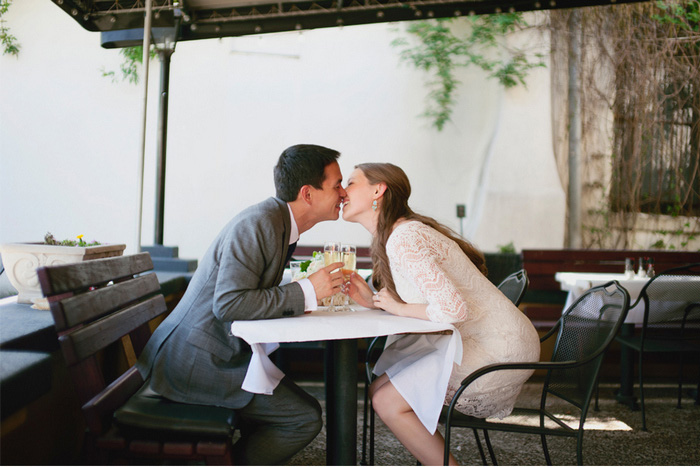 eloping couple kissing over cupcakes