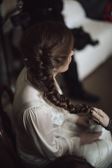 bride having her hair braided