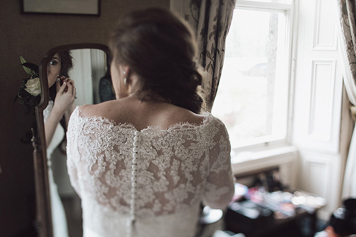 bride putting on her earrings