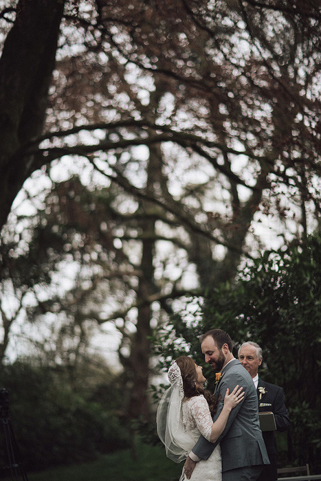 bride and groom hugging at ceremony