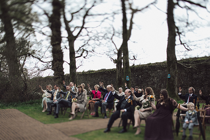 wedding guests blessing the couple