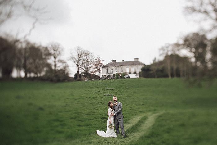 bride and groom on country inn grounds