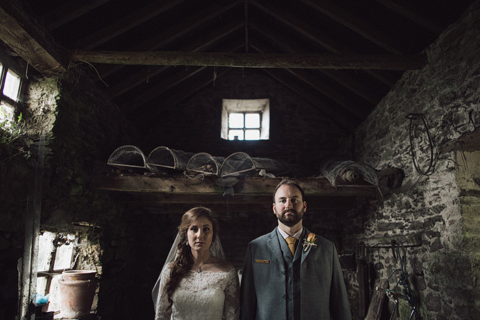 bride and groom in stone shed