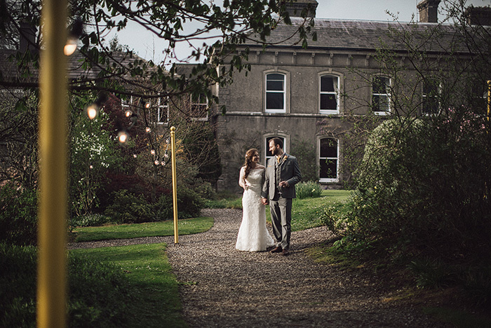 bride and groom walking towards reception tent