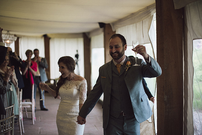 bride and groom entering reception tent