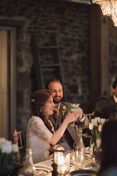 bride and groom toasting with martinis