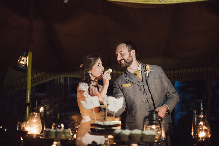 bride and groom feeding each other cake