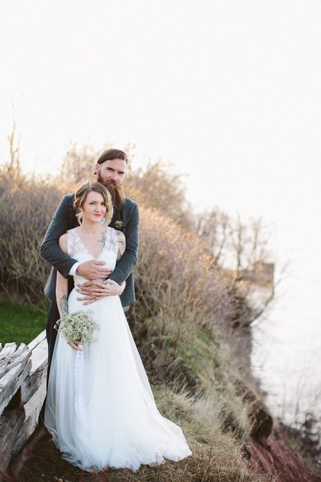 groom embracing bride from behind