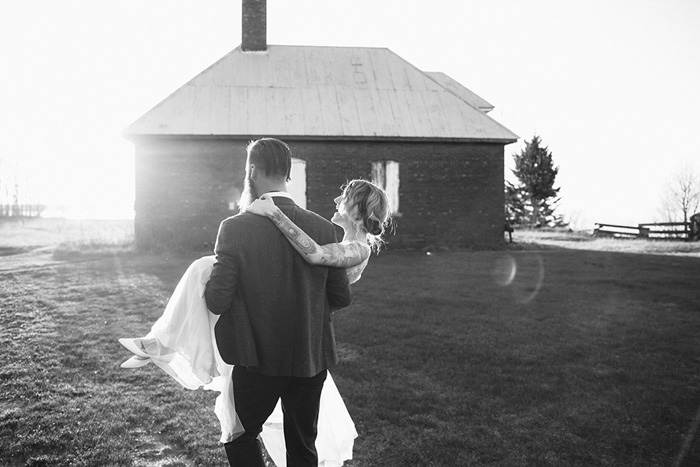 groom carrying bride