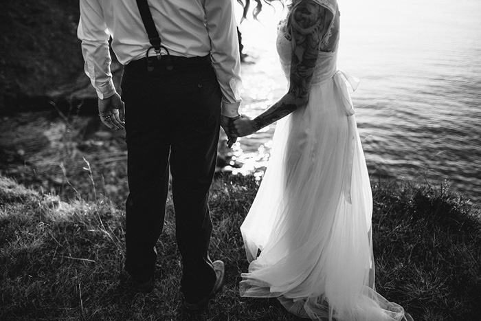 bride and groom walking by lake