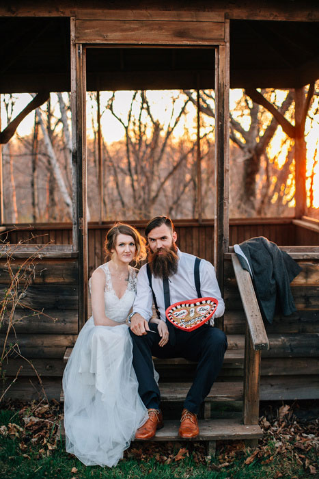 bride and groom with large heart shaped cookie