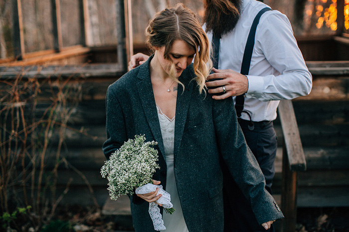 bride wearing groom's jacket