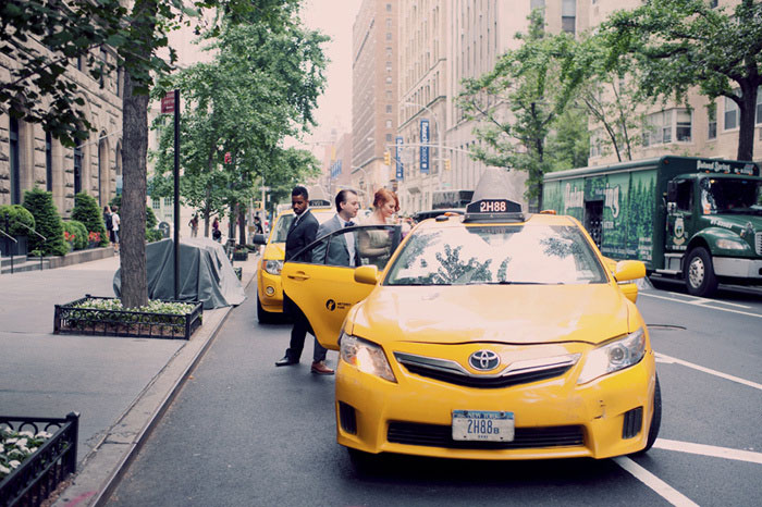 groom getting into yellow taxi